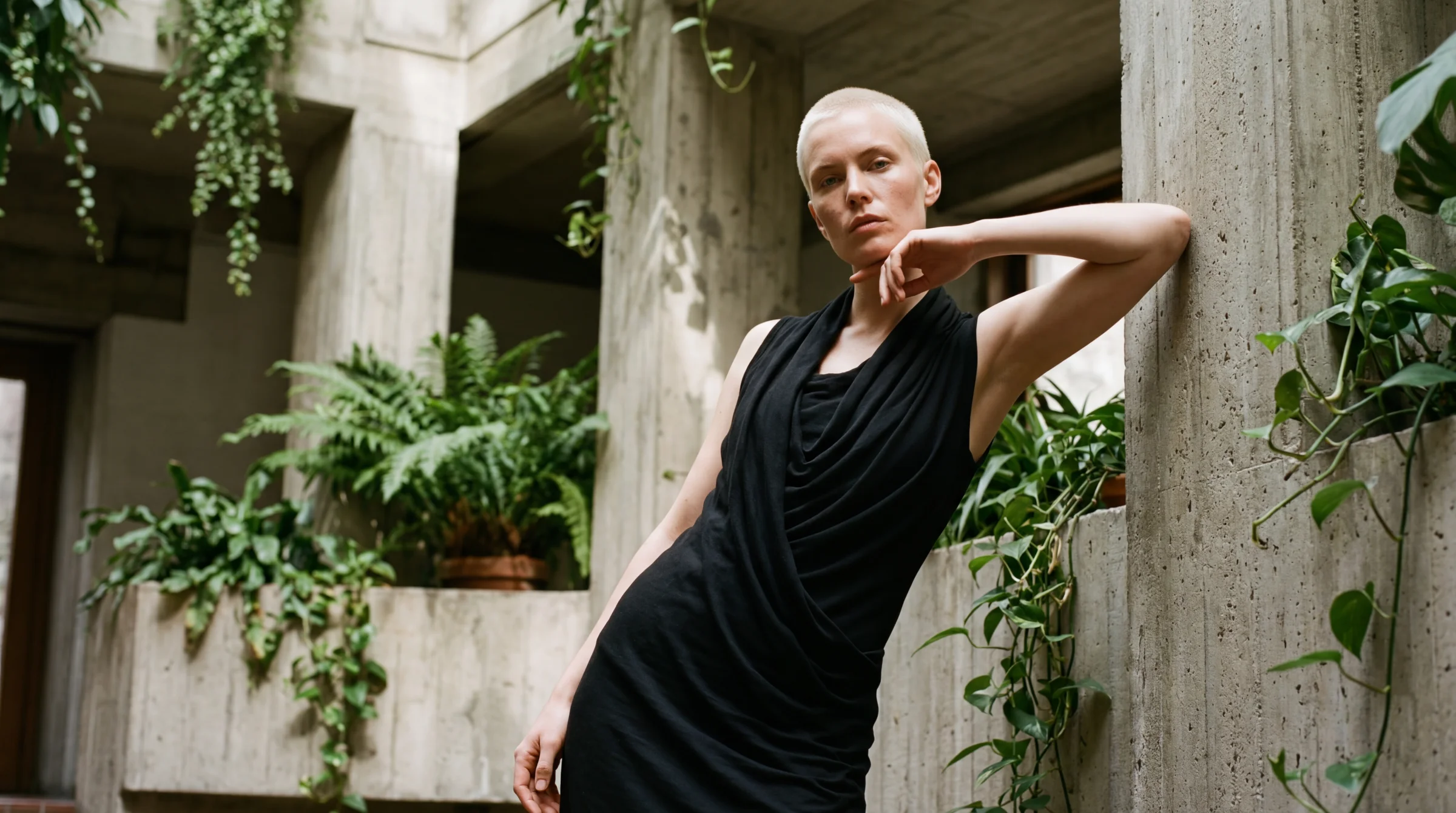 v4 — the 35mm Rick Owens portrait. Beautiful. Natural environmental framing, the drape catching the concrete column behind her. James said "v4 is fucking so nice."